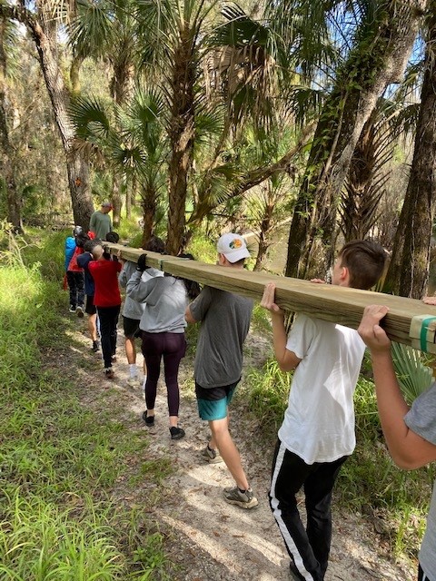 Volunteers building the Radio Crossing bridge deck over the ravine