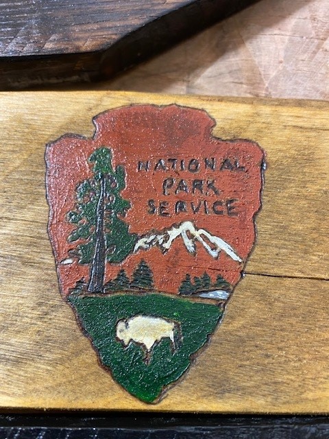 A volunteer hand-staining the Radio Crossing bridge railing