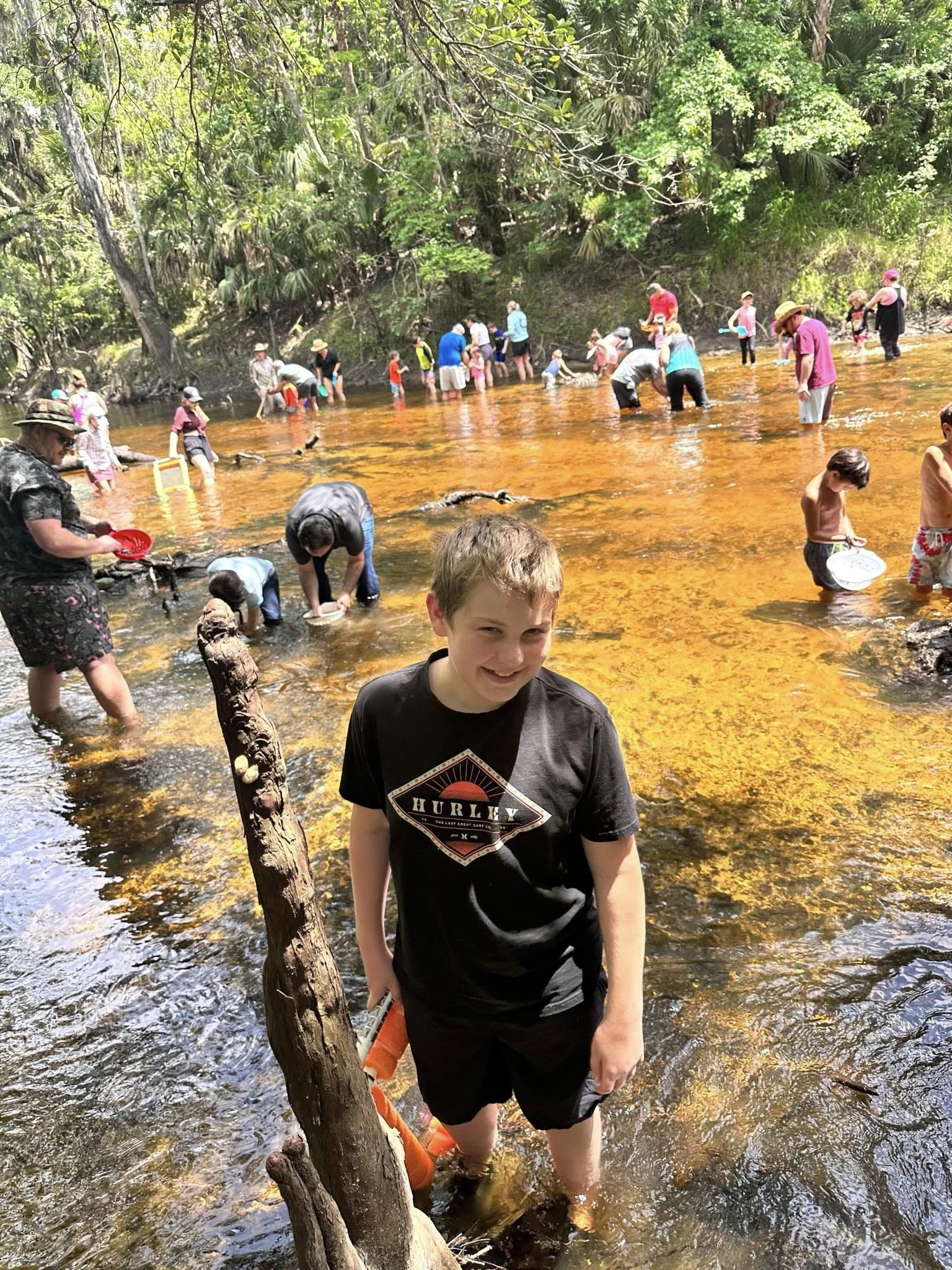 Dozens of residents wading in the amber Alafia River, sieving gravel and searching for fossil shark teeth